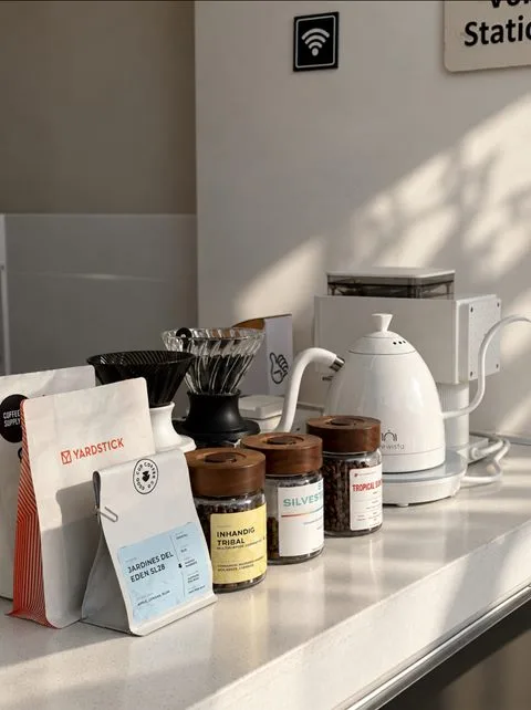 The brew station at Zayn Coffee with a kettle, coffee bean jars and bags of specialty coffee