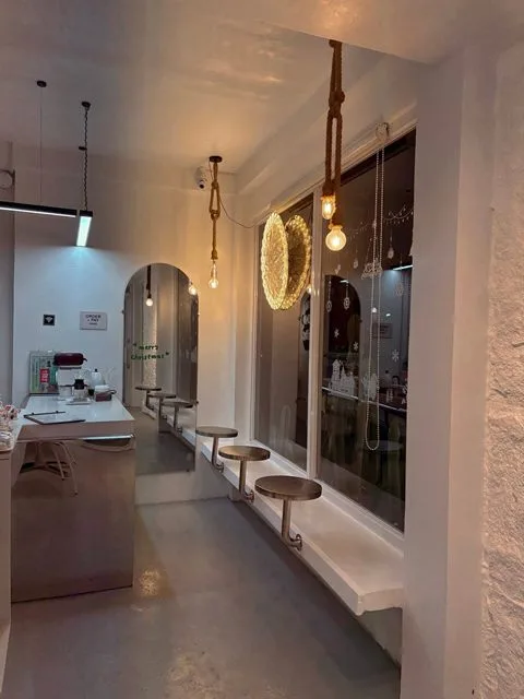 Rope pendant lights and an arched mirror inside Zayn Coffee in Hilongos